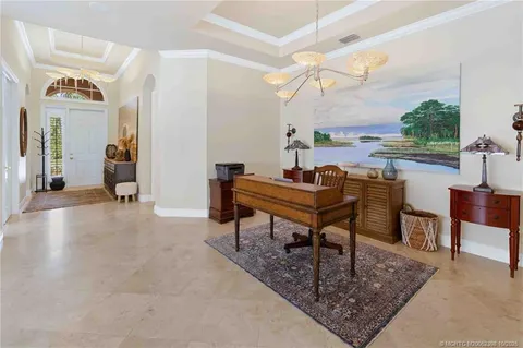 a large kitchen with kitchen island a large window in it and a dining table