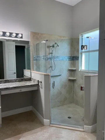 a bathroom with a shower and a sink