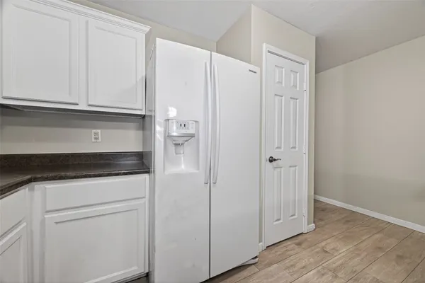 a view of cabinets and wooden floor