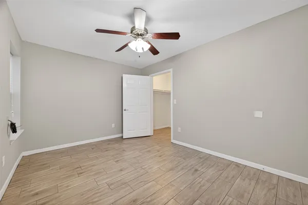 a view of an empty room with wooden floor