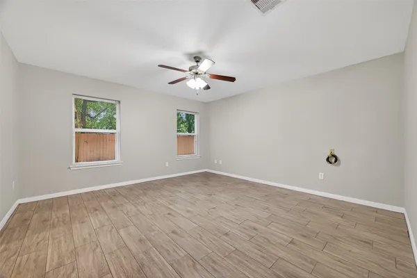wooden floor in an empty room with a window