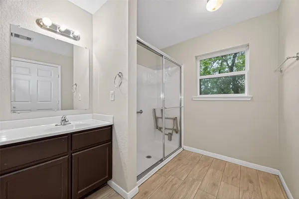 a bathroom with a double vanity sink and mirror