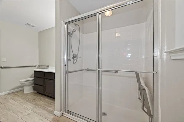 a bathroom with a shower and a glass door