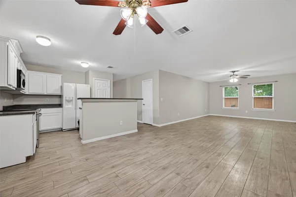 a view of a kitchen with a dishwasher cabinets and wooden floor