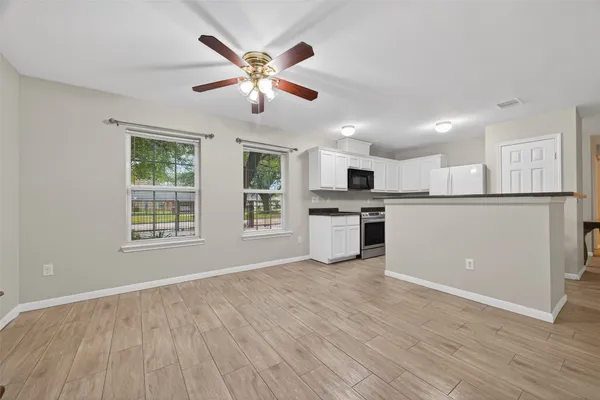 a view of kitchen with cabinets and wooden floor