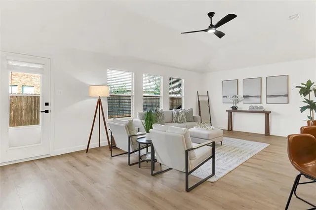 a living room with furniture and a wooden floor