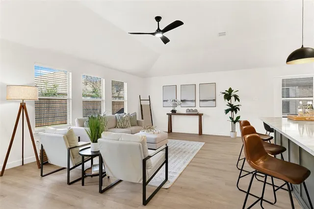 a living room with furniture a window and a chandelier