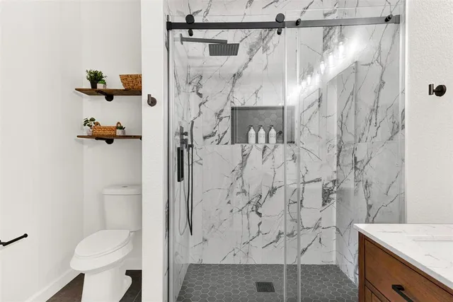 a bathroom with a shower and toilet