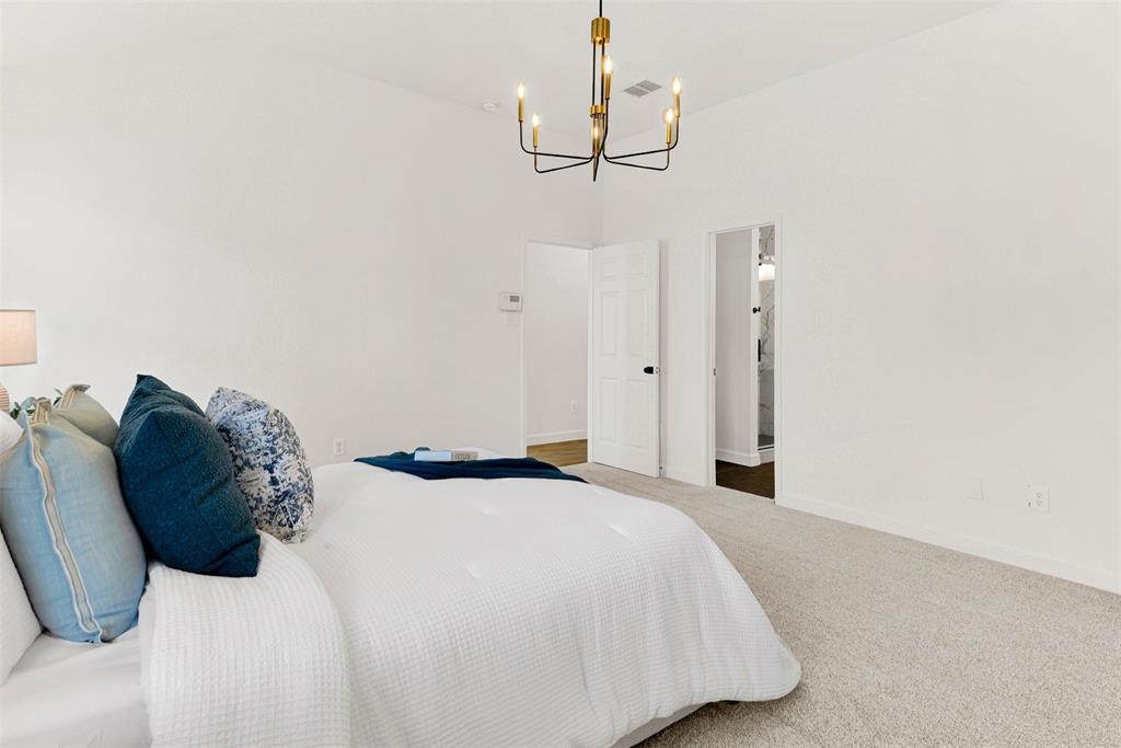 3601 Cottonwood Road Melissa, TX 75454 - Photo 17 of 36 a bedroom with a bed and a chandelier