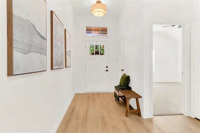 a room with a window and a rug