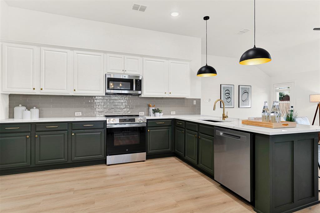 3601 Cottonwood Road Melissa, TX 75454 - Photo 4 of 36 a kitchen with stainless steel appliances granite countertop a sink a stove and cabinets