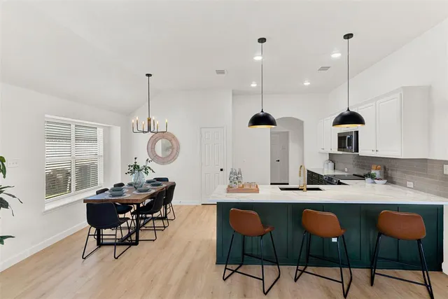 a very nice looking dining room with furniture window and wooden floor
