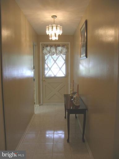 6221 Commons Road Rosedale, MD 21237 - Photo 2 of 27 a room with furniture and a chandelier