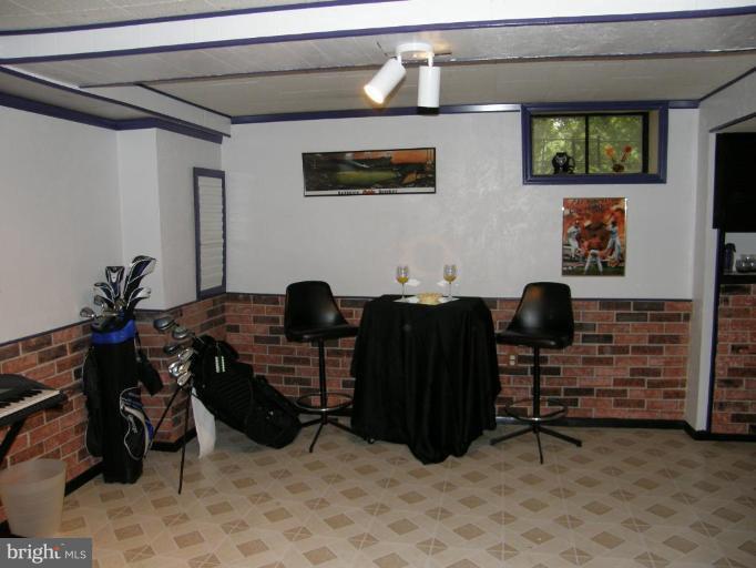 6221 Commons Road Rosedale, MD 21237 - Photo 16 of 27 a view of workspace with wooden floor and furniture