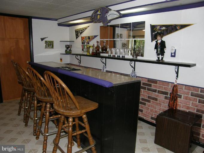 6221 Commons Road Rosedale, MD 21237 - Photo 25 of 27 a kitchen with a sink and chairs