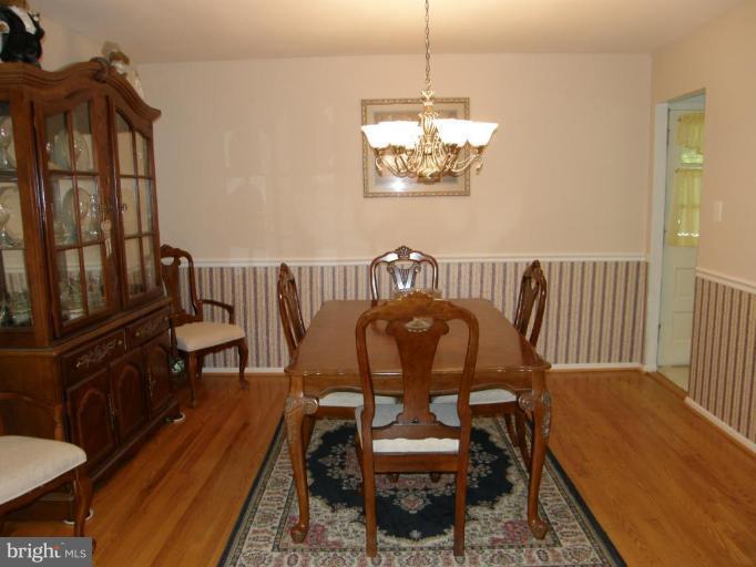 6221 Commons Road Rosedale, MD 21237 - Photo 4 of 27 a view of a dining room with furniture window and wooden floor