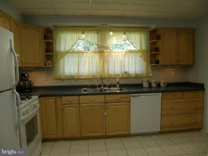 6221 Commons Road Rosedale, MD 21237 - Photo 5 of 27 a kitchen with stainless steel appliances granite countertop a sink and cabinets