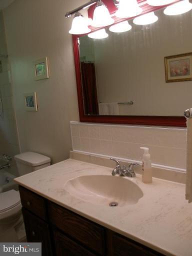 6221 Commons Road Rosedale, MD 21237 - Photo 9 of 27 a bathroom with a sink and a mirror