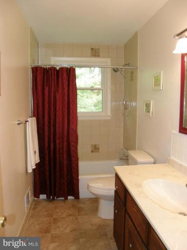 6221 Commons Road Rosedale, MD 21237 - Photo 10 of 27 a bathroom with a granite countertop sink toilet and shower