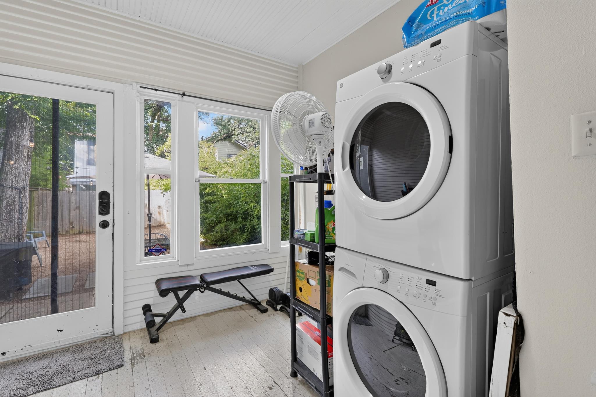 307 East 35th Street, Unit A Austin, TX 78705 - Photo 29 of 40 A dedicated laundry space offers convenience and a seamless connection to the outdoors through an exterior glass door.