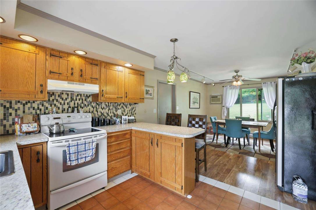 2371 Honeysuckle Road Allentown, PA 18103 - Photo 11 of 25 Warm wooden cabinetry and stone counters define this functional culinary space.