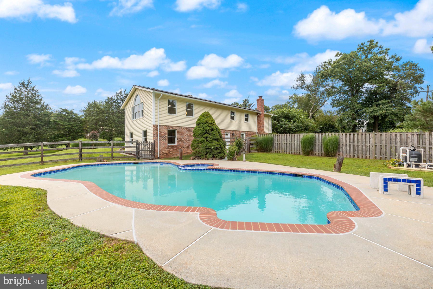 18604 Muncaster Road Rockville, MD 20855 - Photo 12 of 90 a view of a swimming pool with a patio and a yard