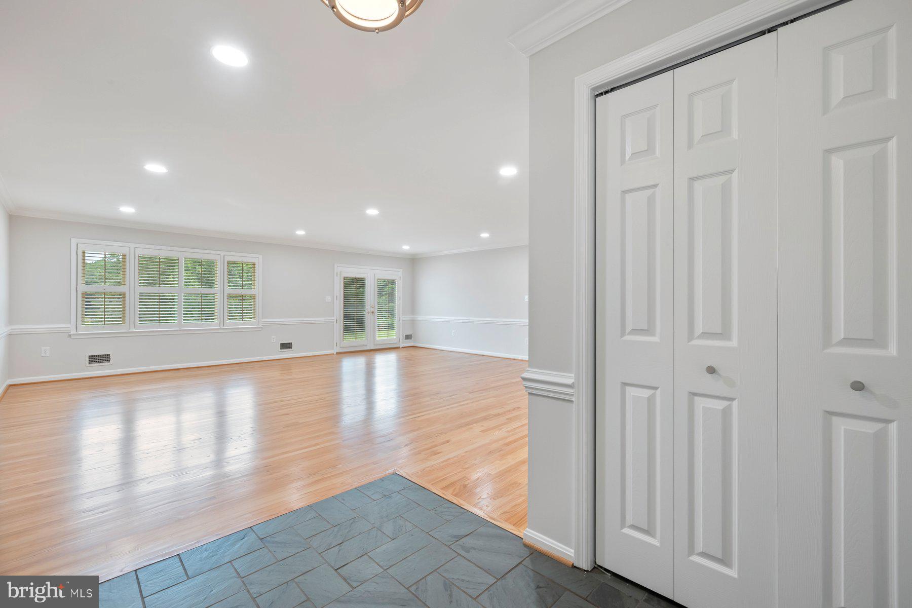 18604 Muncaster Road Rockville, MD 20855 - Photo 23 of 90 an empty room with wooden floor and windows