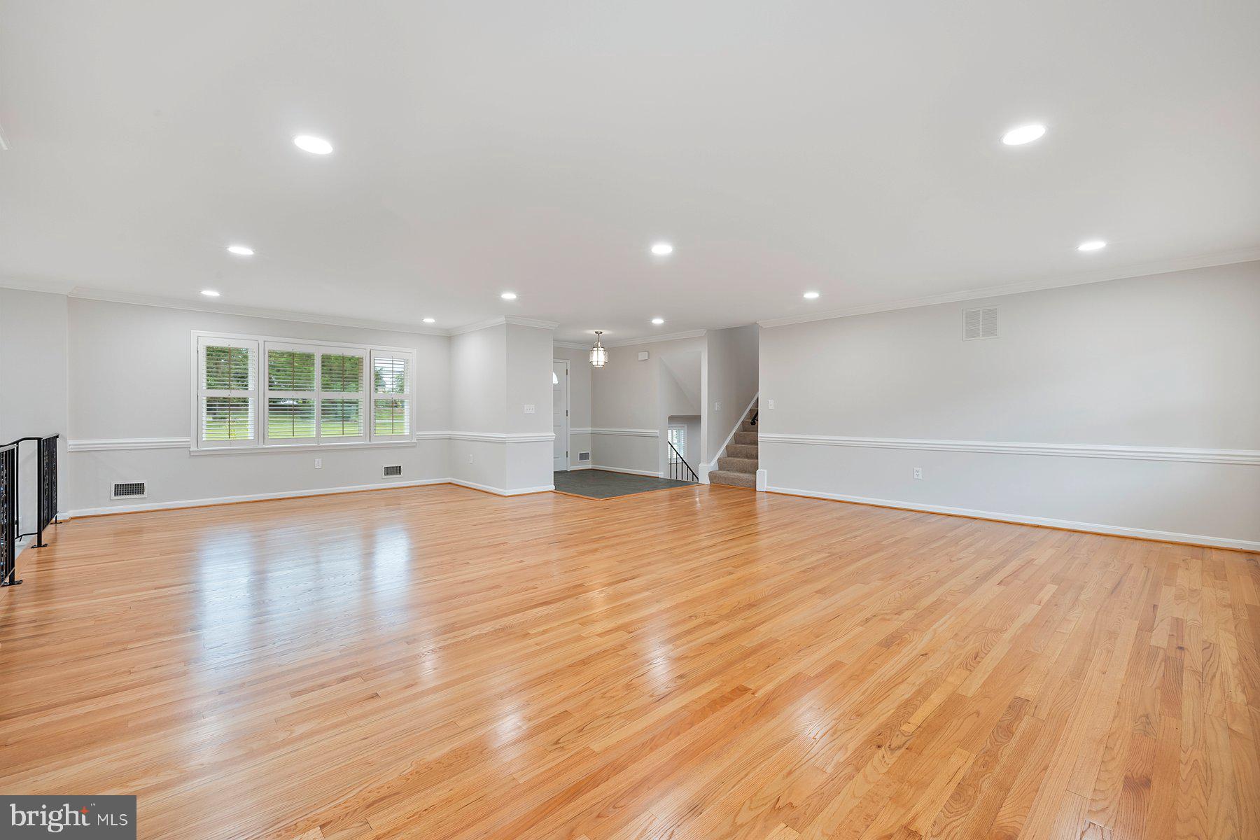 18604 Muncaster Road Rockville, MD 20855 - Photo 24 of 90 a view of an empty room with wooden floor and a window