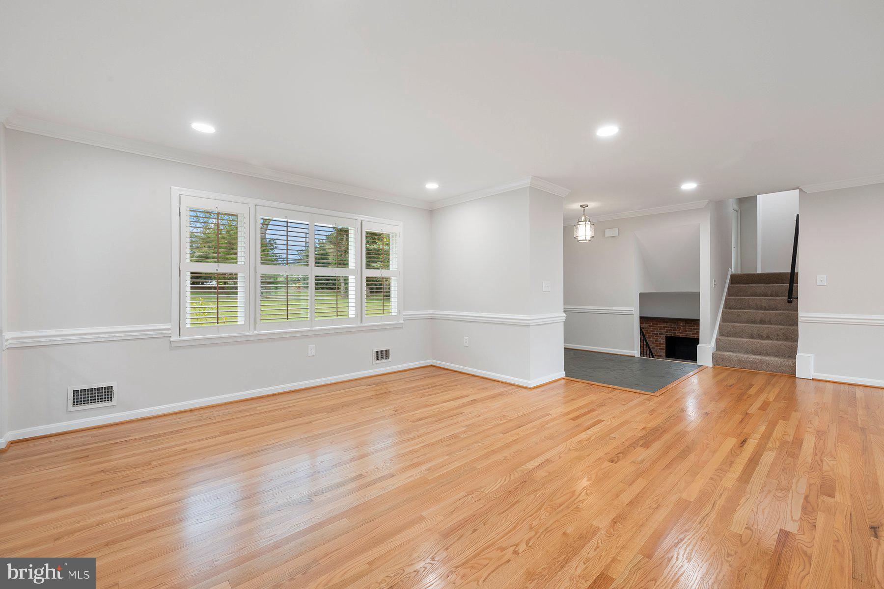 18604 Muncaster Road Rockville, MD 20855 - Photo 25 of 90 a view of an empty room with wooden floor and a window