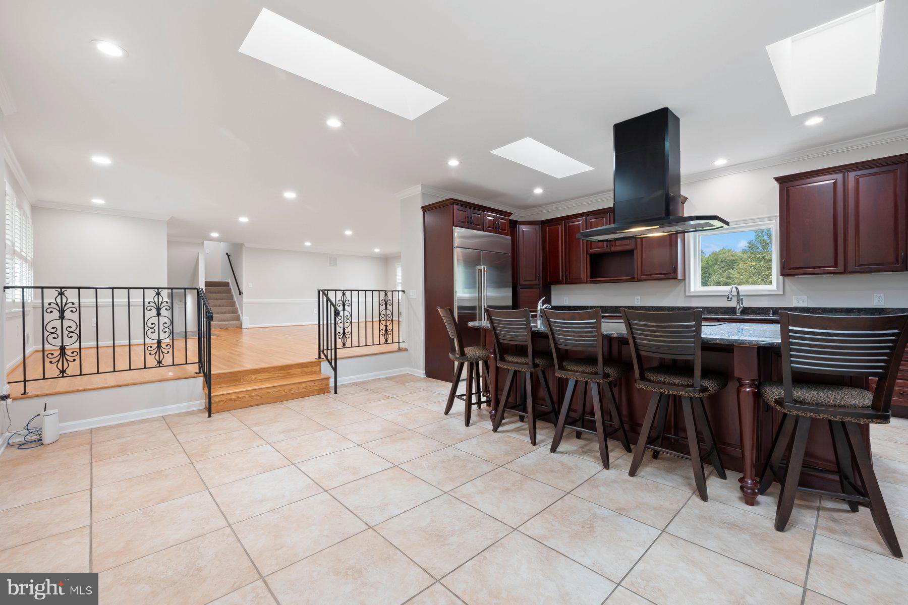 18604 Muncaster Road Rockville, MD 20855 - Photo 27 of 90 a open kitchen with stainless steel appliances kitchen island granite countertop a table and chairs in it