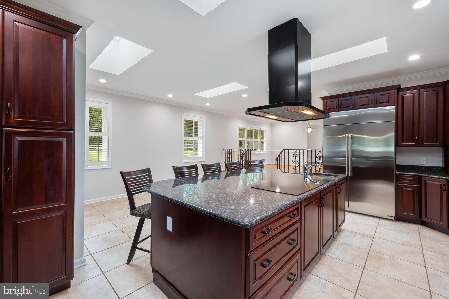 18604 Muncaster Road Rockville, MD 20855 - Photo 30 of 90 a kitchen with stainless steel appliances granite countertop a sink a stove and a refrigerator