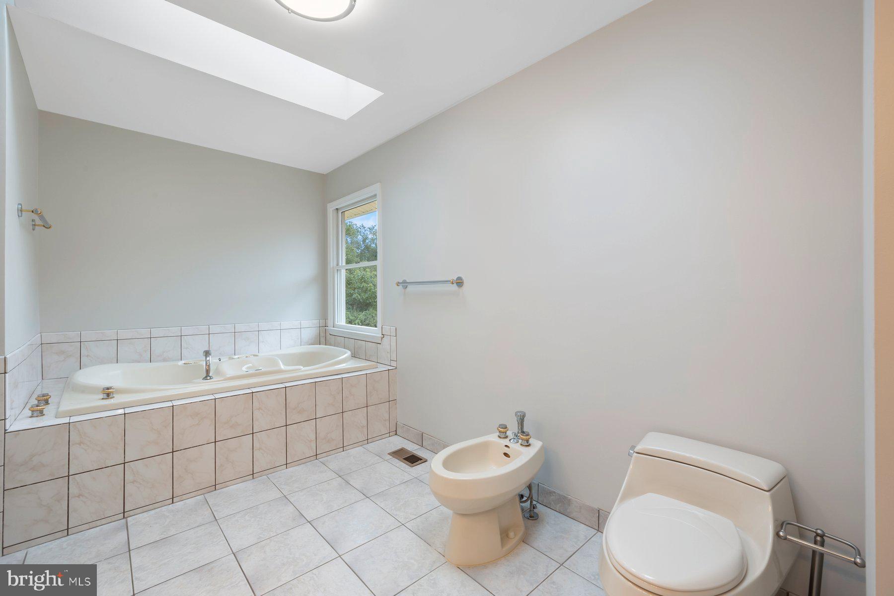 18604 Muncaster Road Rockville, MD 20855 - Photo 47 of 90 a bathroom with a toilet a sink and mirror