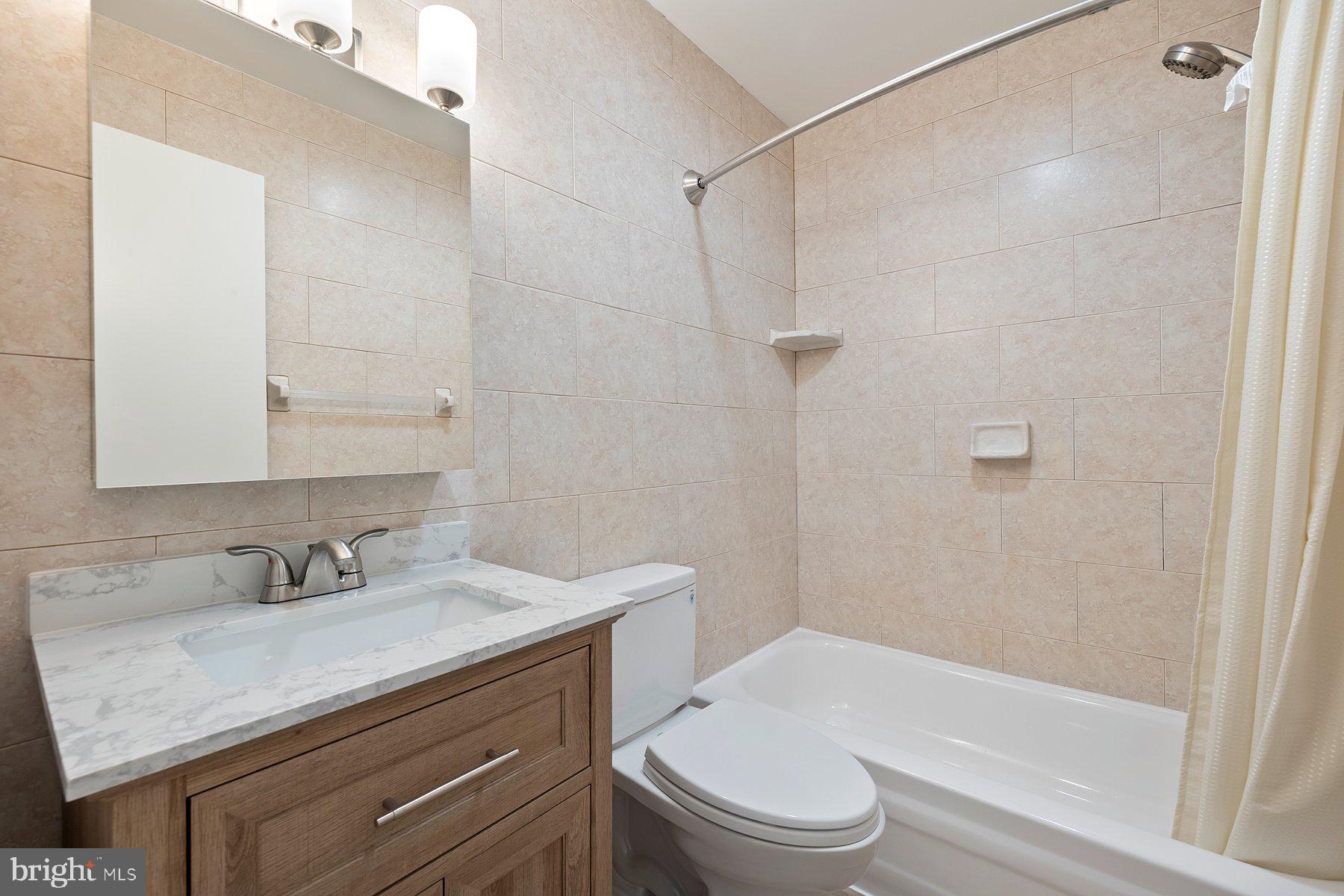 18604 Muncaster Road Rockville, MD 20855 - Photo 54 of 90 a bathroom with a sink toilet vanity and shower