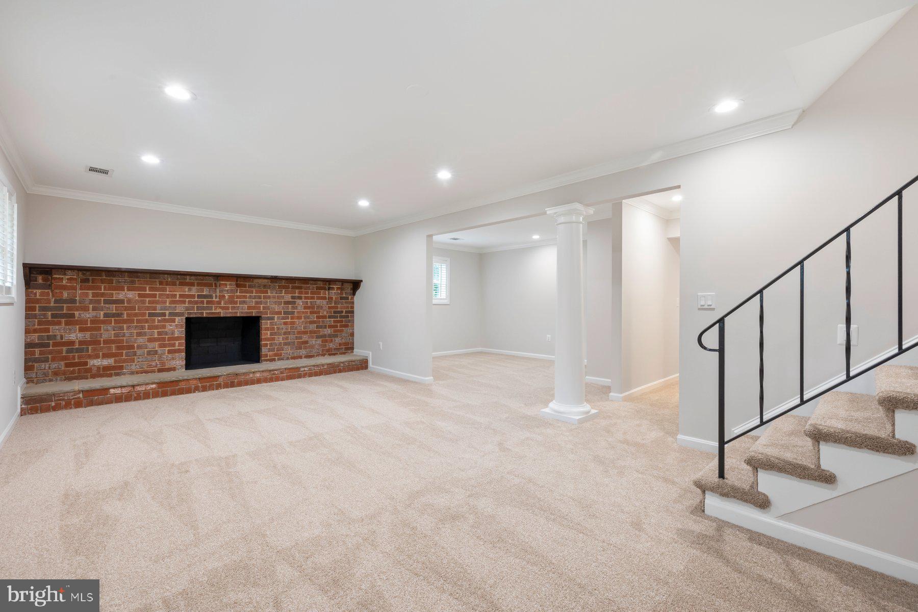 18604 Muncaster Road Rockville, MD 20855 - Photo 56 of 90 a view of an empty room with wooden floor and a fireplace