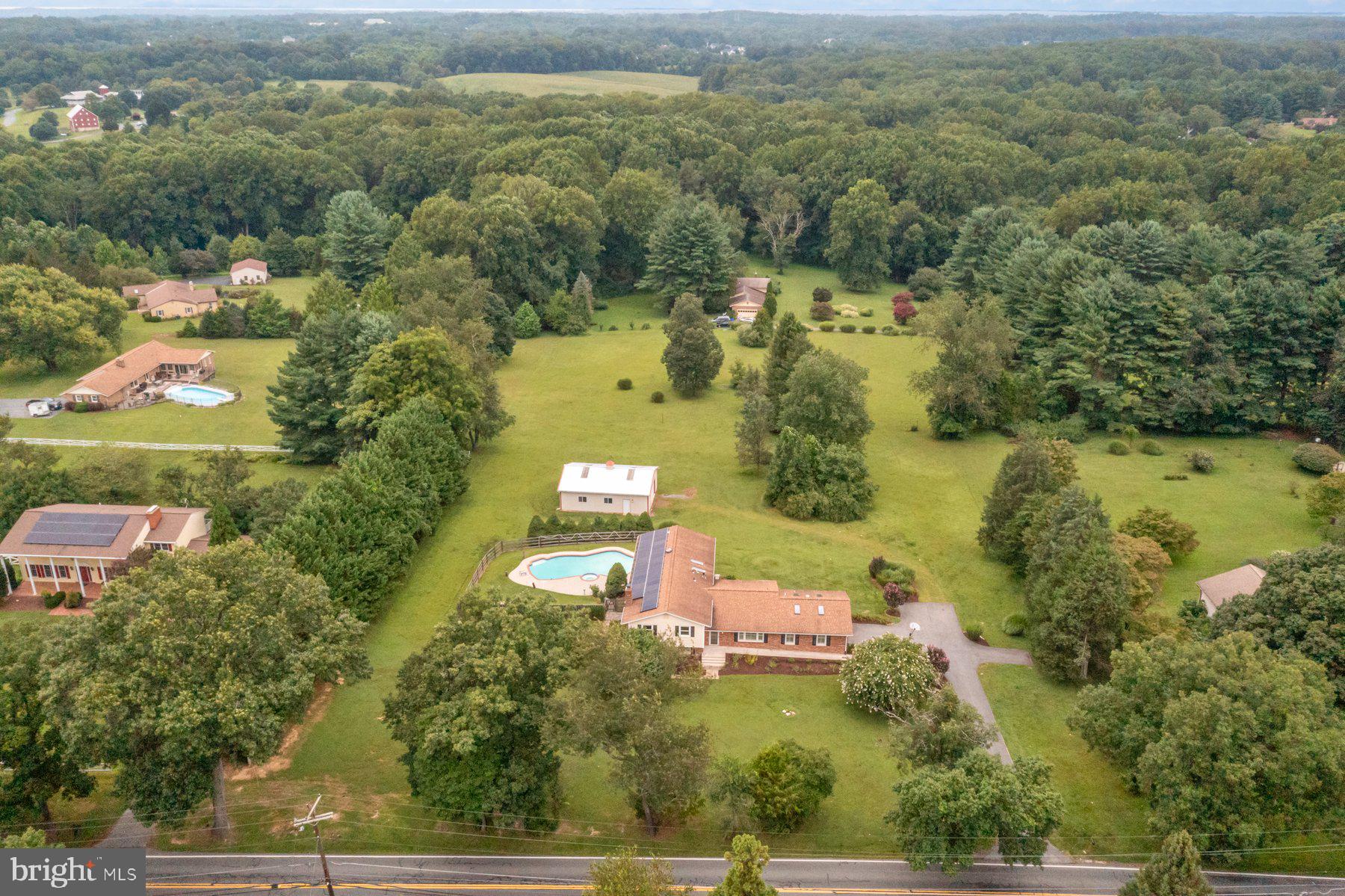 18604 Muncaster Road Rockville, MD 20855 - Photo 6 of 90 an aerial view of residential houses with outdoor space and trees