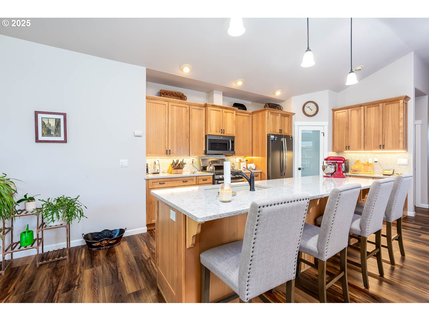 8413 Forest Ridge Loop Redmond, OR 97756 - Photo 12 of 40 a kitchen with stainless steel appliances kitchen island granite countertop a table chairs sink and cabinets
