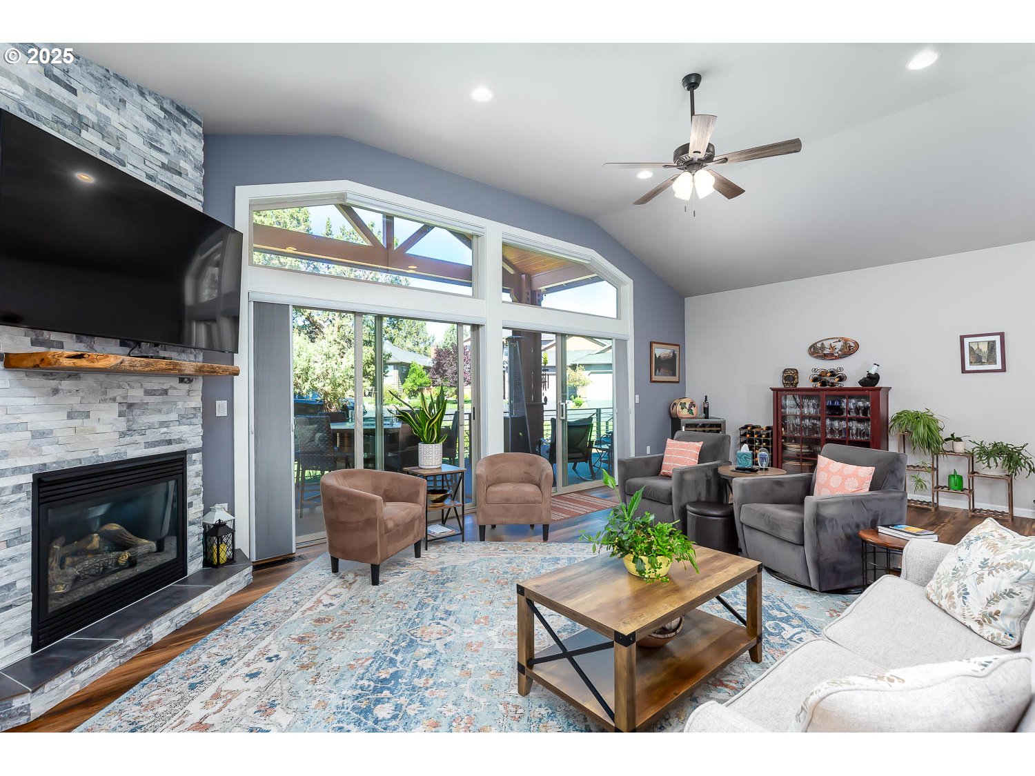 8413 Forest Ridge Loop Redmond, OR 97756 - Photo 5 of 40 a living room with furniture a flat screen tv and a fireplace