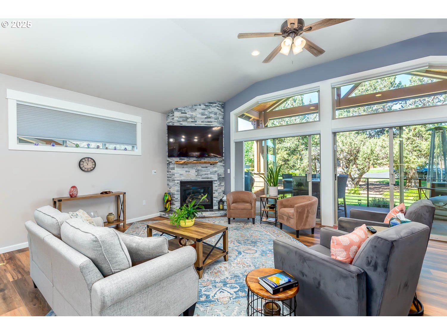 8413 Forest Ridge Loop Redmond, OR 97756 - Photo 6 of 40 a living room with furniture a fireplace and a large window