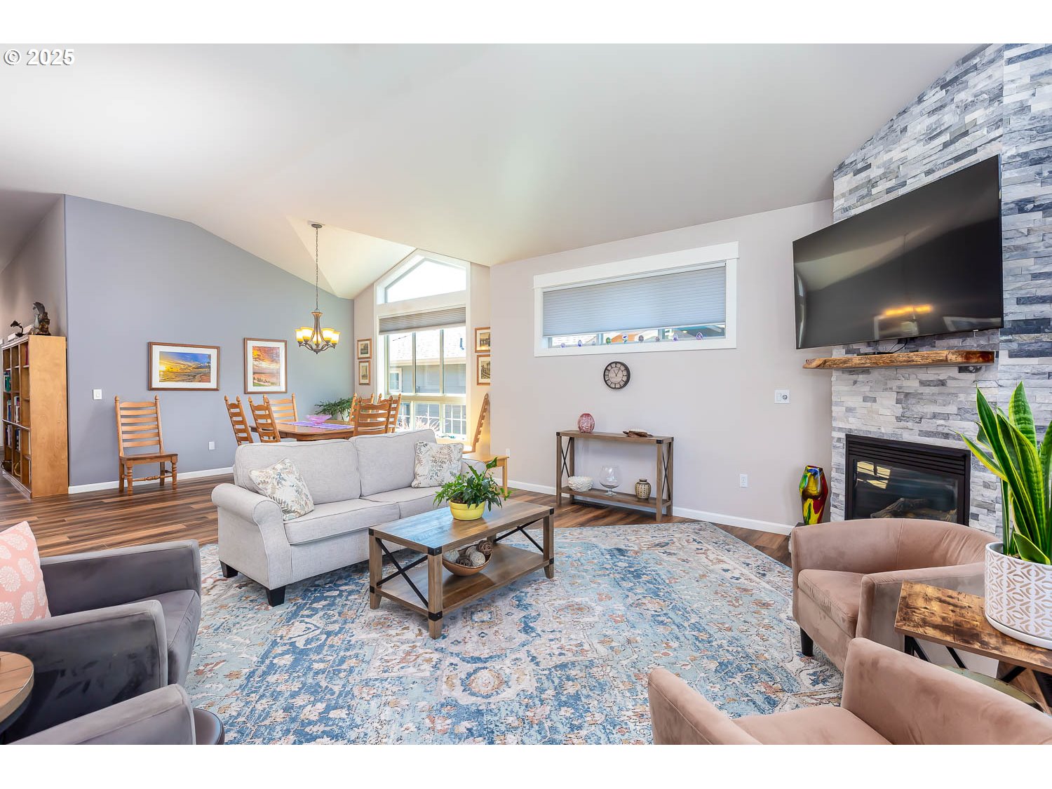 8413 Forest Ridge Loop Redmond, OR 97756 - Photo 7 of 40 a living room with furniture a flat screen tv and a fireplace