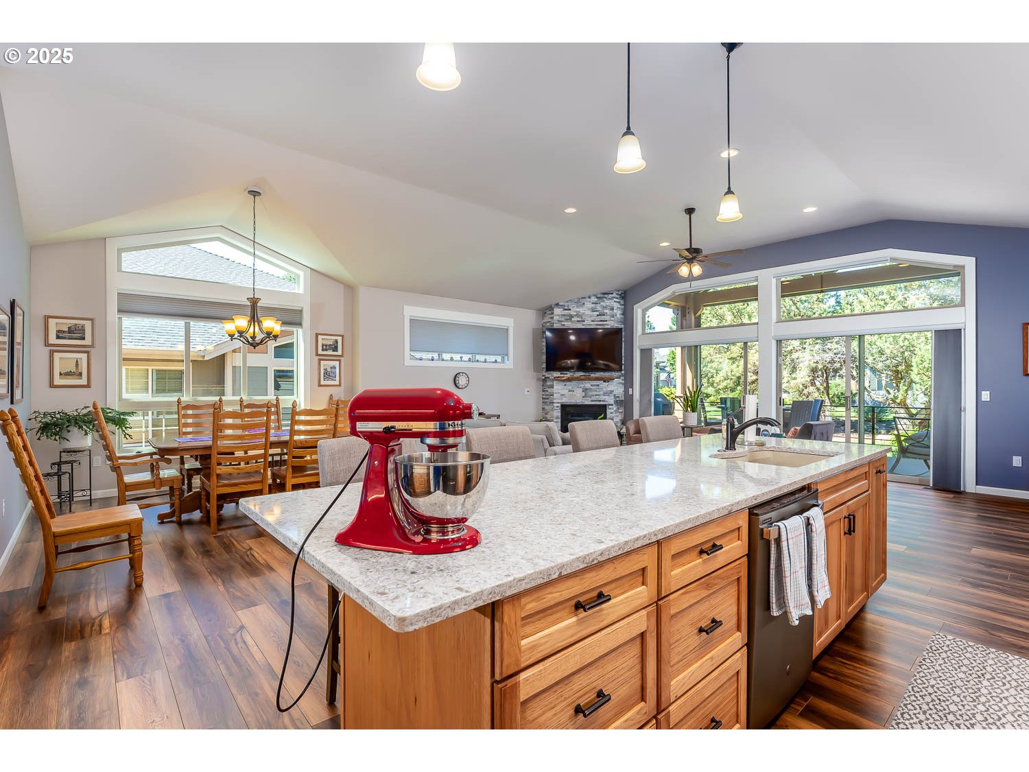8413 Forest Ridge Loop Redmond, OR 97756 - Photo 8 of 40 a kitchen with kitchen island granite countertop a stove dining table chairs and wooden floor