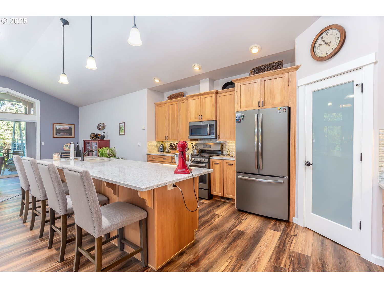 8413 Forest Ridge Loop Redmond, OR 97756 - Photo 10 of 40 a open kitchen with stainless steel appliances granite countertop a dining table chairs refrigerator and cabinets