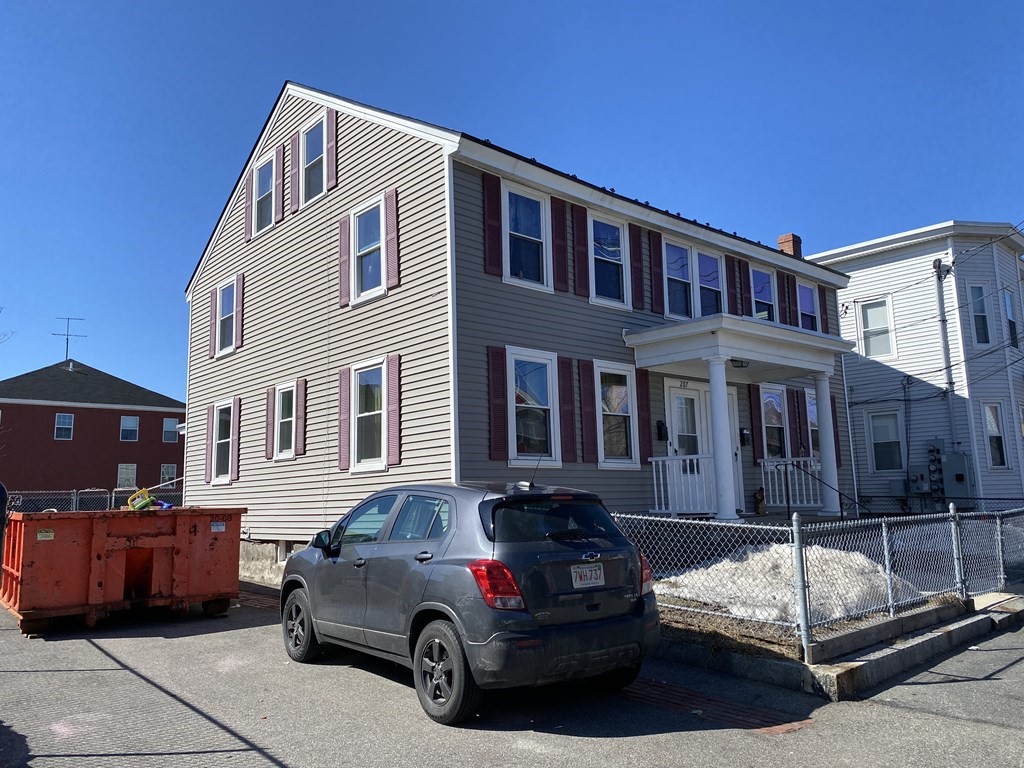 285 High Street Lowell, MA 01852 - Photo 3 of 8 a car parked in front of a house