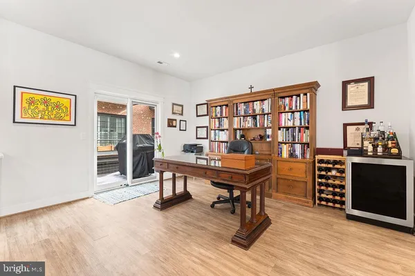 a kitchen with stainless steel appliances granite countertop a refrigerator a stove top oven a sink dishwasher a dining table and chairs with wooden floor