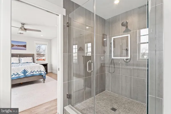 a bathroom with a granite countertop sink a mirror and a toilet