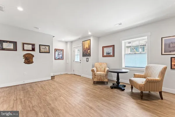 a kitchen with stainless steel appliances granite countertop a white cabinets and wooden floor