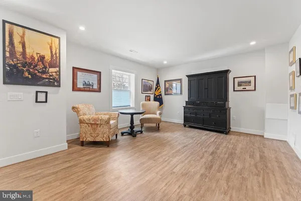 a bedroom with furniture and wooden floor