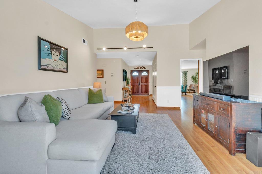 1528 Juniperhill Drive Encinitas, CA 92024 - Photo 15 of 40 a living room with furniture and a flat screen tv
