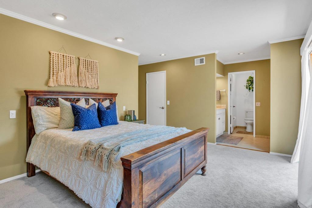1528 Juniperhill Drive Encinitas, CA 92024 - Photo 20 of 40 a bedroom with a bed and a cabinets