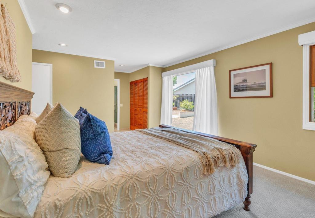 1528 Juniperhill Drive Encinitas, CA 92024 - Photo 21 of 40 a bed sitting in a spacious bedroom next to a window