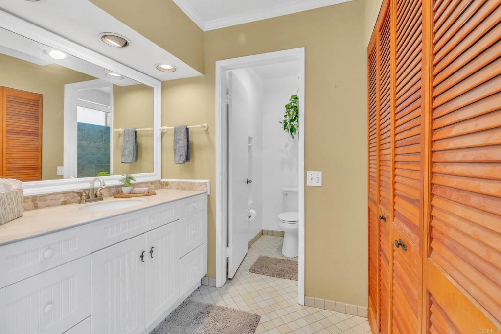 1528 Juniperhill Drive Encinitas, CA 92024 - Photo 22 of 40 a spacious bathroom with a double vanity sink a mirror and a shower